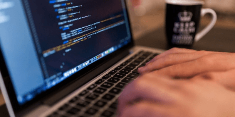 developer writing code on mac
